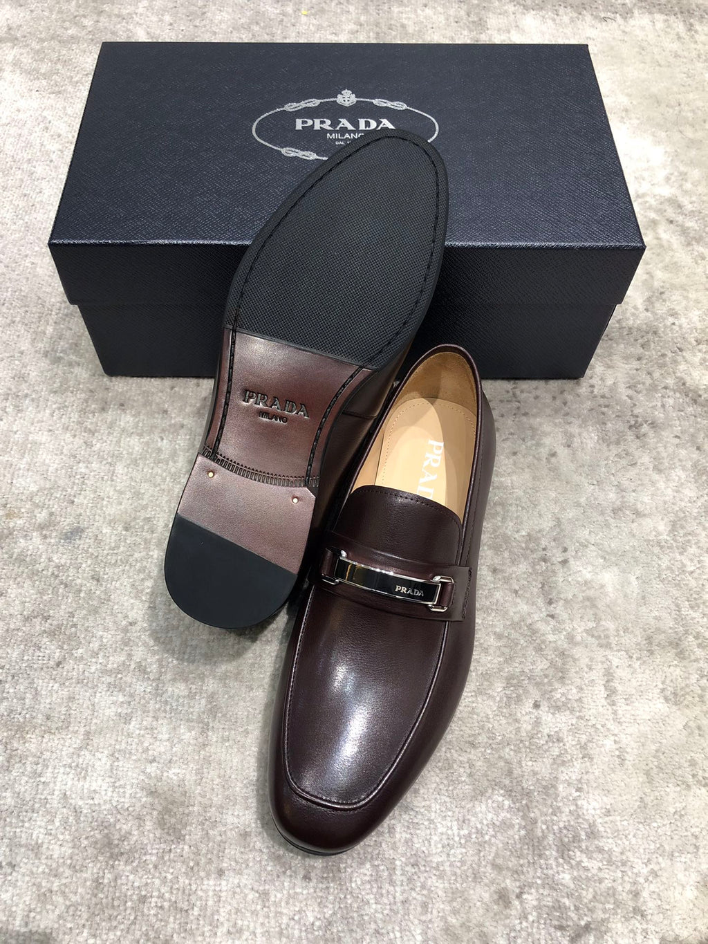 Prada unisex leather loafers, dark brown upper with buckle strap, black outsole