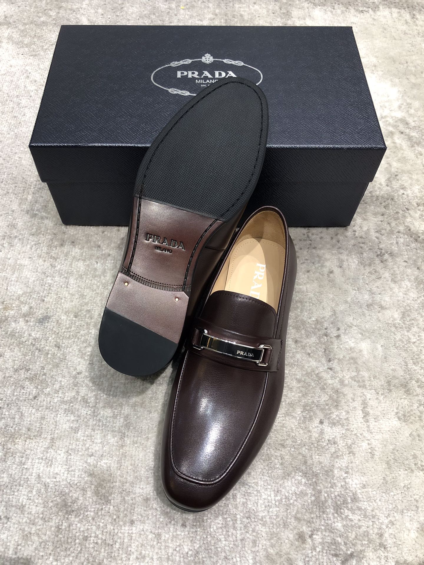 Prada unisex leather loafers, dark brown upper with buckle strap, black outsole