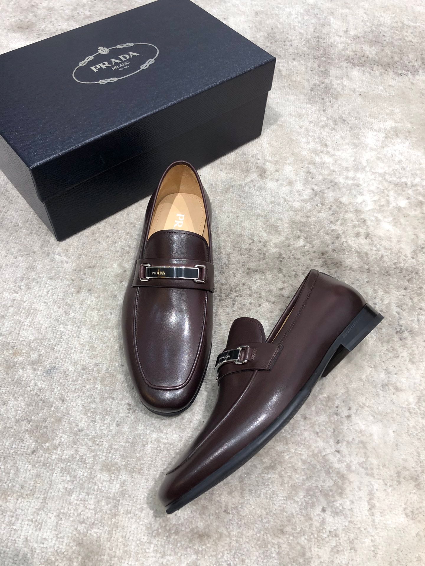 Prada unisex leather loafers, dark brown, slip-on style with buckle strap
