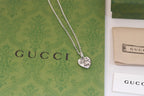 Gucci heart charm necklace with silver-tone chain and engraved heart pendant