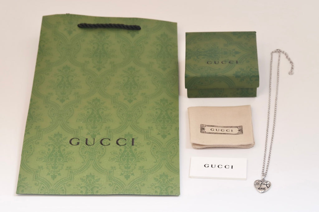 Gucci heart charm necklace with silver-tone chain and heart charm pendant