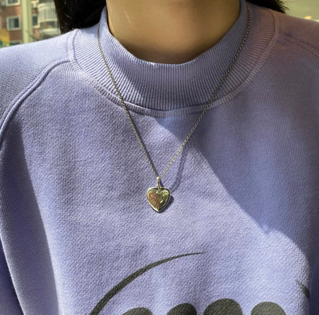 Gold-tone Gucci heart pendant necklace on a silver-tone chain