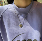 Gold-tone Gucci heart pendant necklace on a silver-tone chain