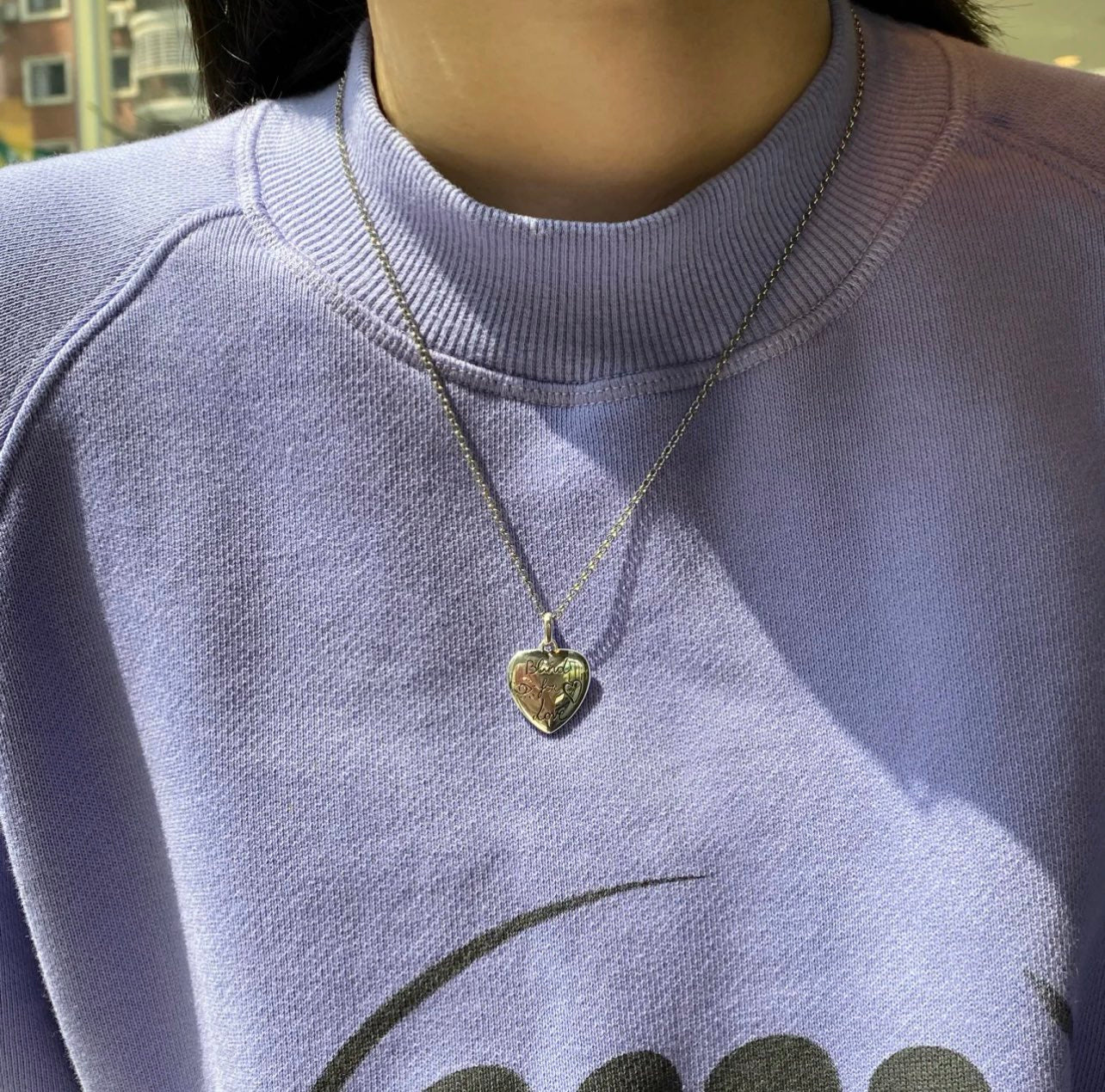 Gold-tone Gucci heart pendant necklace on a silver-tone chain