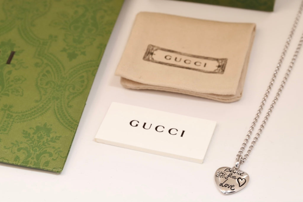 Gucci heart charm necklace with silver-tone chain and round heart pendant