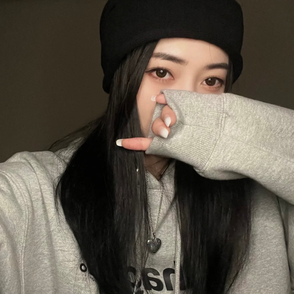 Gucci heart pendant necklace worn with a gray sweatshirt and face covering