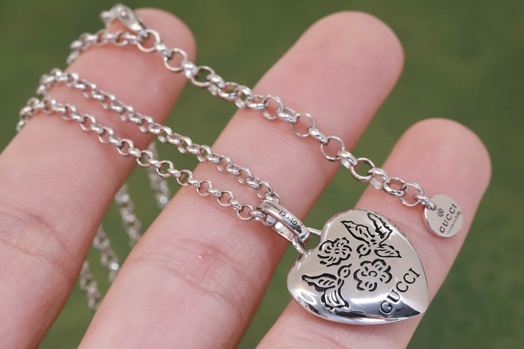 Gucci heart charm necklace with silver-tone chain and engraved heart pendant
