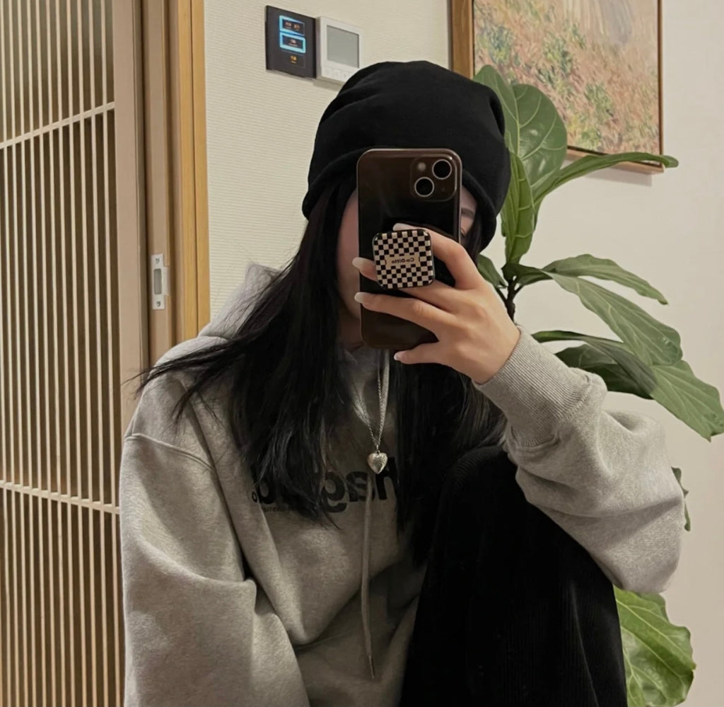 Gucci heart pendant necklace worn with a gray sweatshirt and black beanie