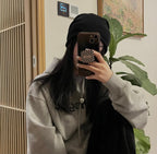 Gucci heart pendant necklace worn with a gray sweatshirt and black beanie