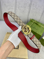 Gucci belt, beige GG canvas strap with red underside and large gold-tone G buckle.