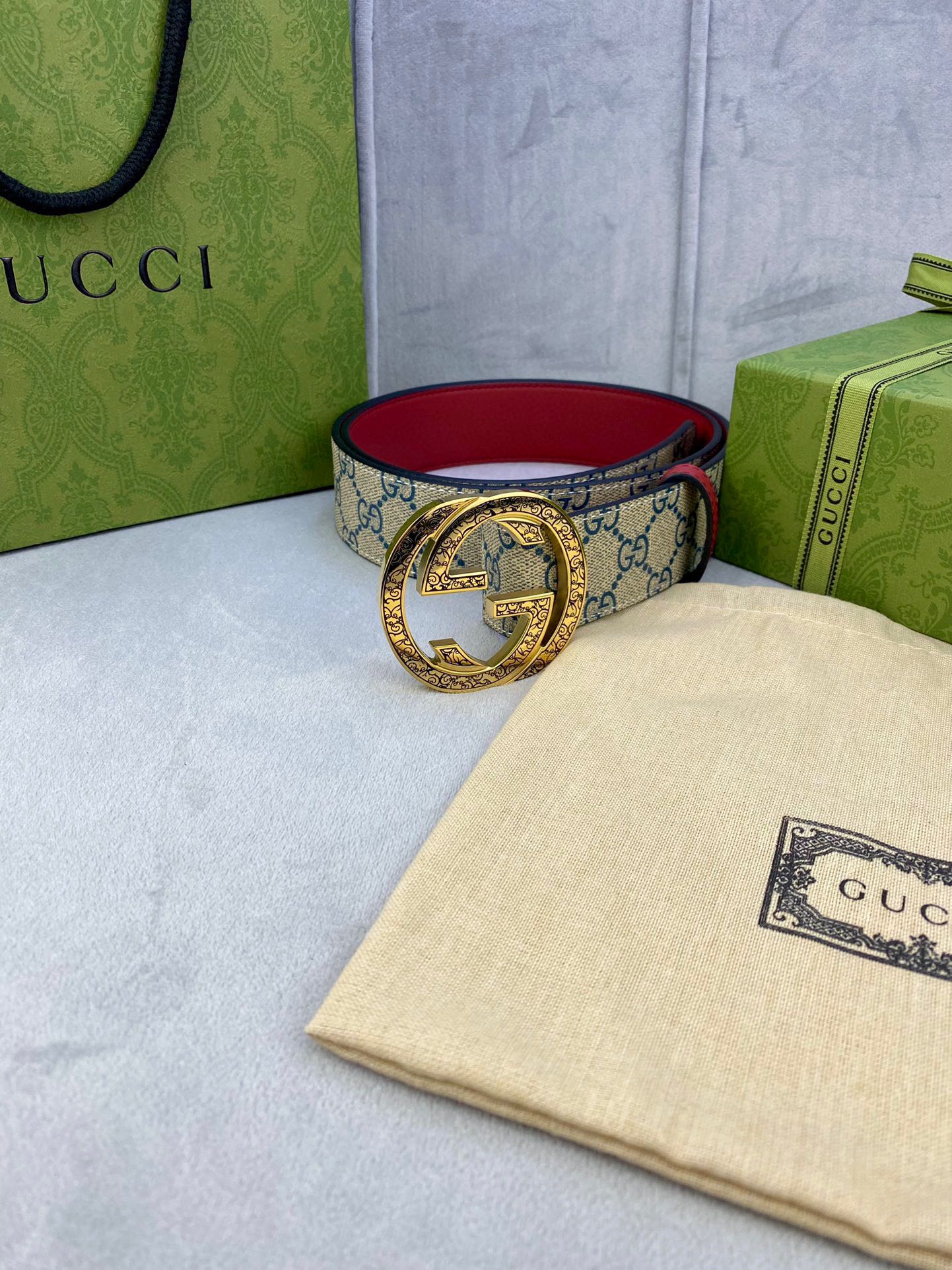 Gucci GG canvas belt with red interior and gold-tone round buckle, side view