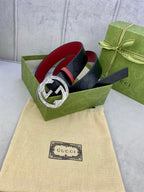 Gucci belt in dark blue with red lining and large round gold buckle