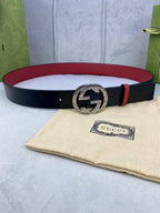 Gucci belt with dark navy monogram strap, gold-toned G buckle, red leather trim