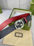 Gucci belt with dark logo strap, red underside, ornate gold-tone G buckle
