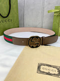 Gucci belt with brown leather strap, green-and-red web stripe, and round gold-tone buckle.