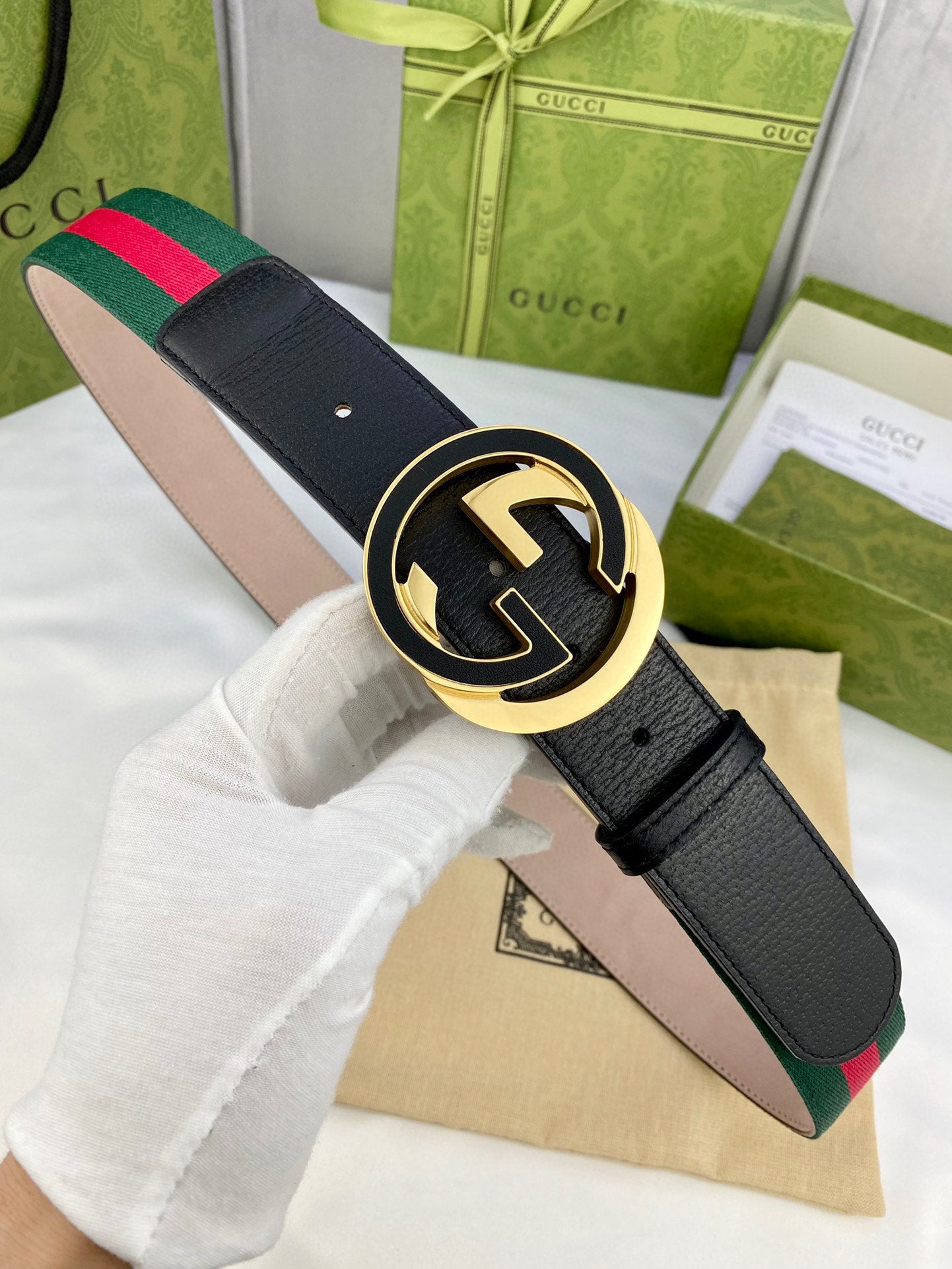 Black leather belt with gold-tone GG buckle and green-red web stripe