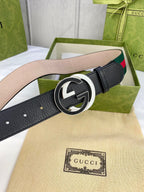 Black leather belt with gold-tone GG buckle and green-red web stripe detail