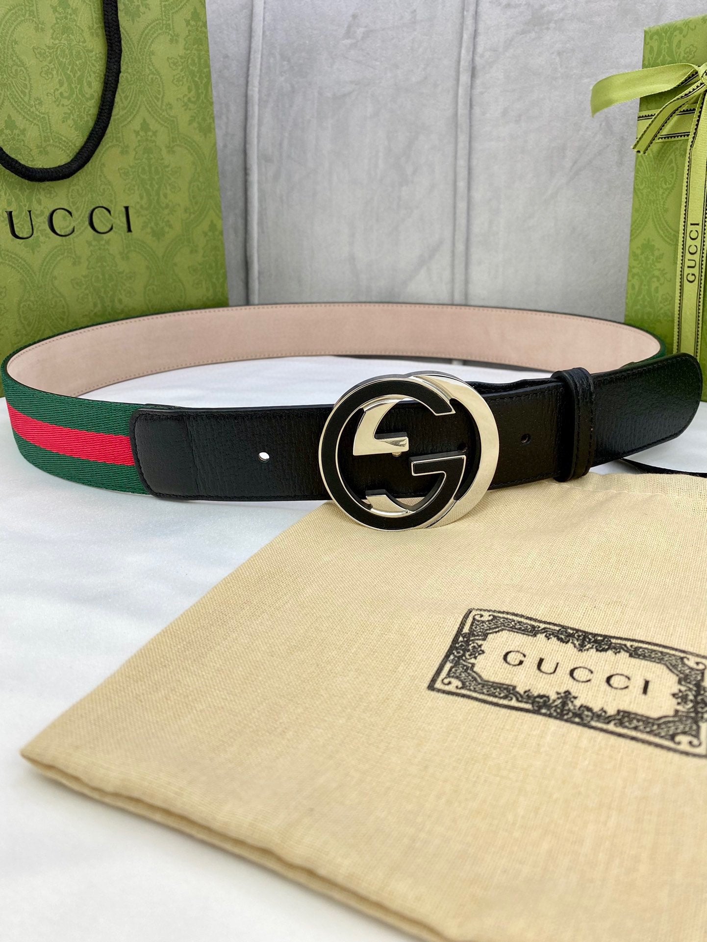 Gucci belt with black leather, gold-tone GG buckle, and green-red web stripe
