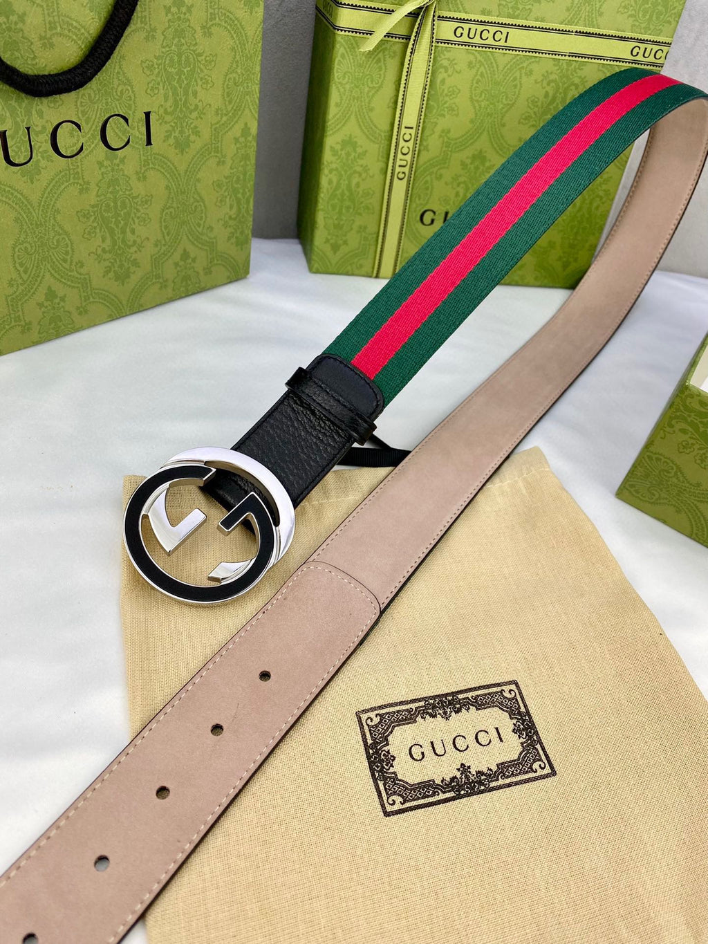Leather belt with gold-tone GG buckle, light interior, and green-red web stripe
