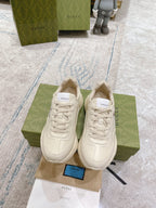 Gucci unisex white sneakers, lace-up pair viewed from above