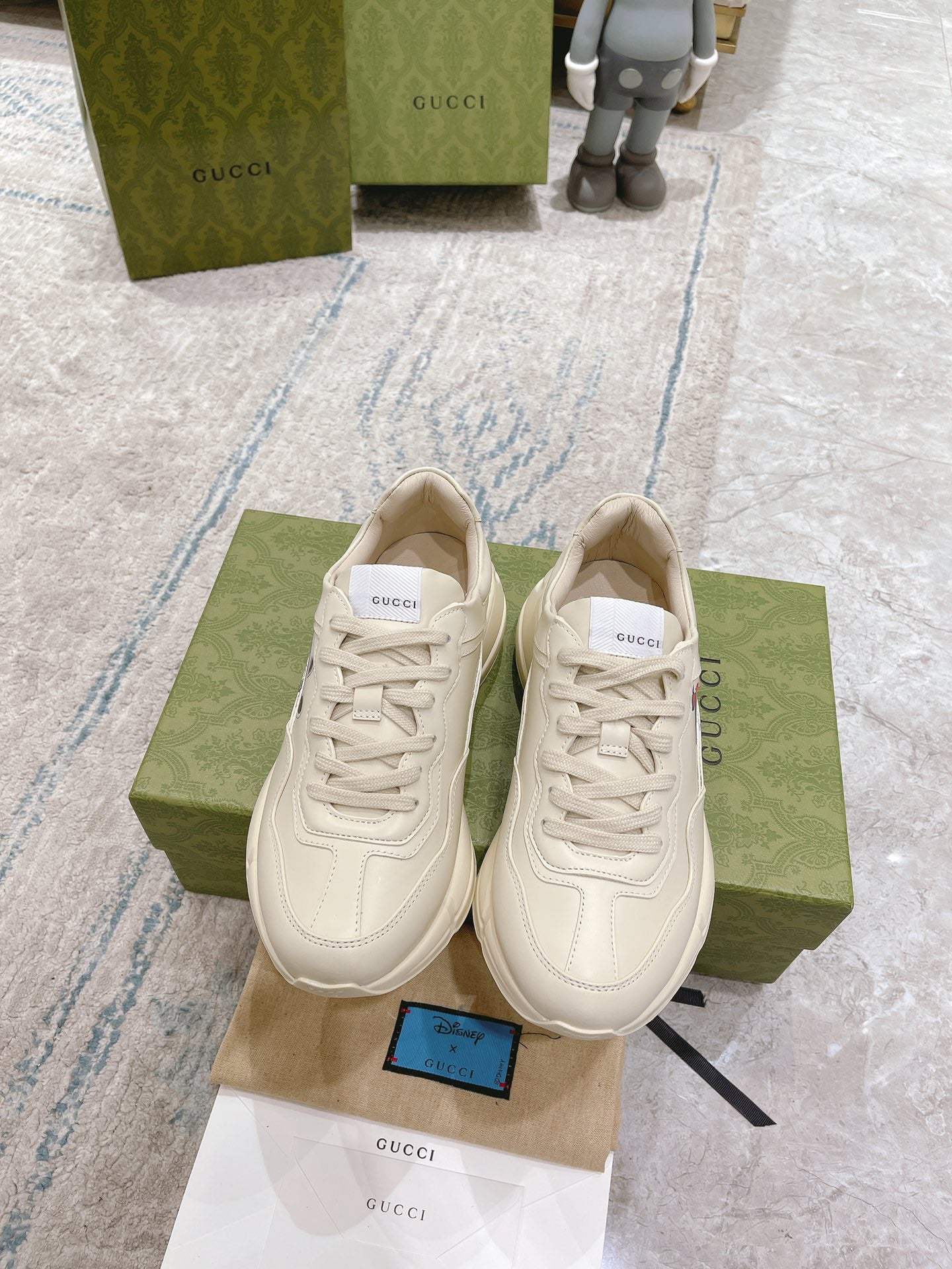 Gucci unisex white sneakers, lace-up pair viewed from above