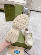 Gucci unisex white sneaker outsole view with textured tread and Gucci marks