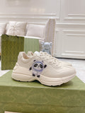 Gucci unisex white chunky sneakers with panda logo detail and lace-up front