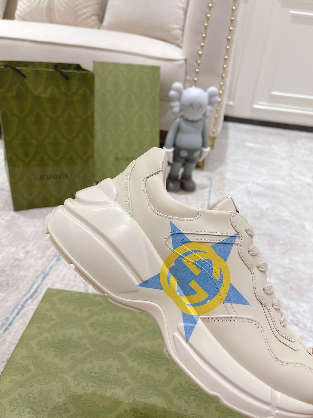 White Gucci unisex sneaker with blue star and GG logo, close side view