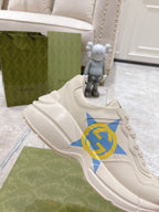 White Gucci unisex sneaker with blue star and GG logo, close side view