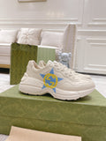 White Gucci unisex sneakers with blue star and yellow GG logo, lace-up design