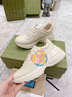 White Gucci unisex sneakers with GG heart logo, close-up on shoebox
