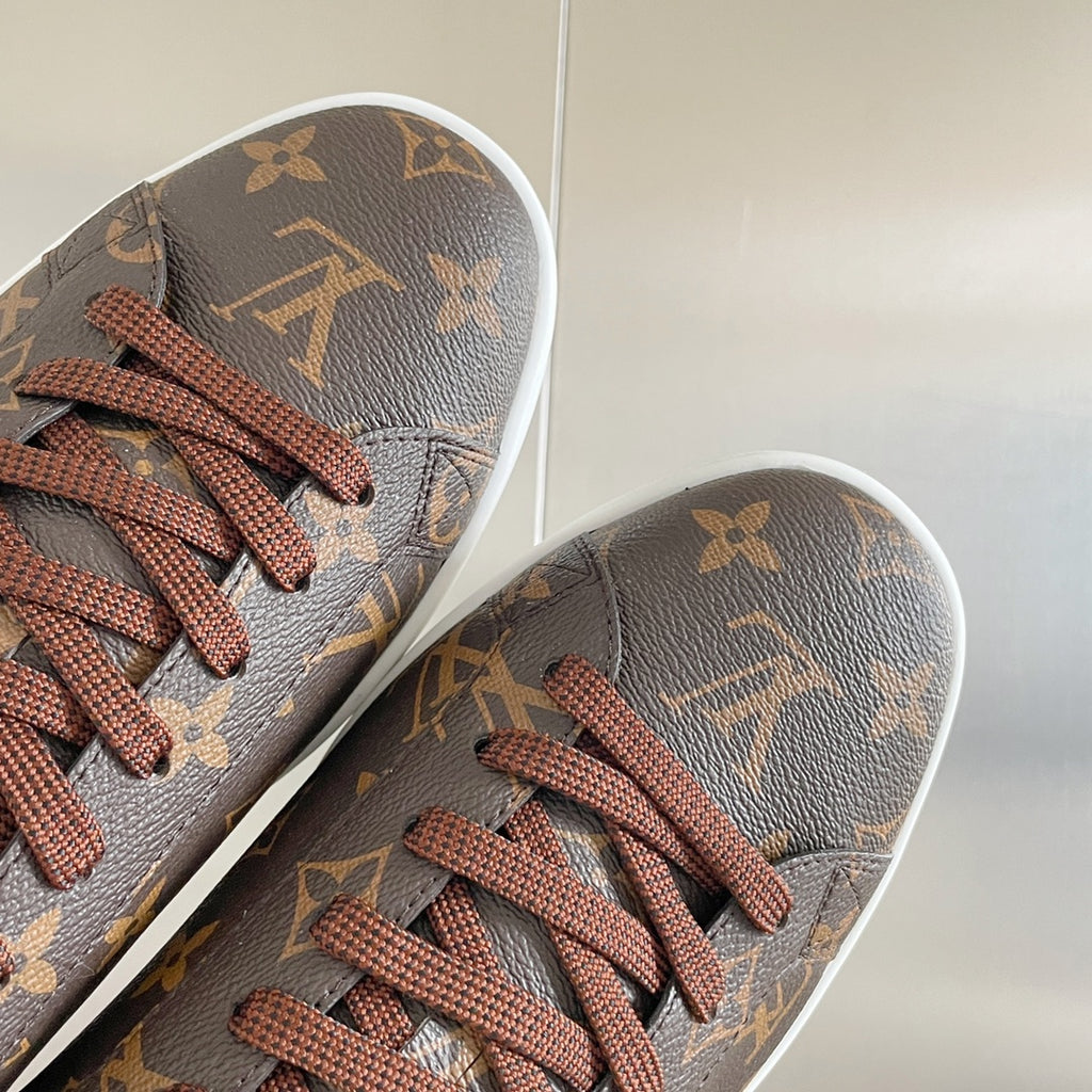 Louis Vuitton unisex sneaker toe with monogram pattern and brown lace-up front.