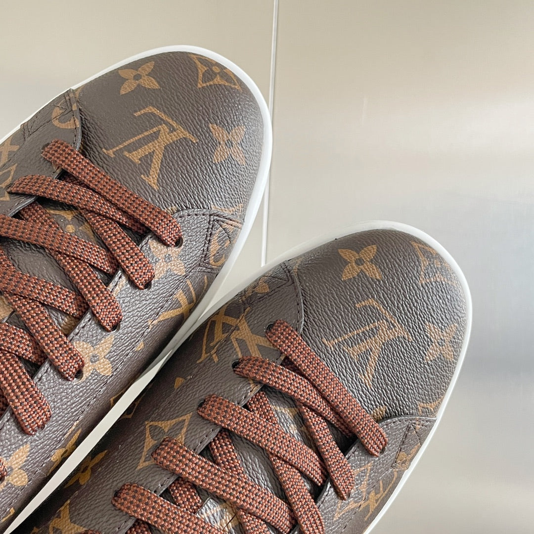 Louis Vuitton unisex sneaker toe with monogram pattern and brown lace-up front.