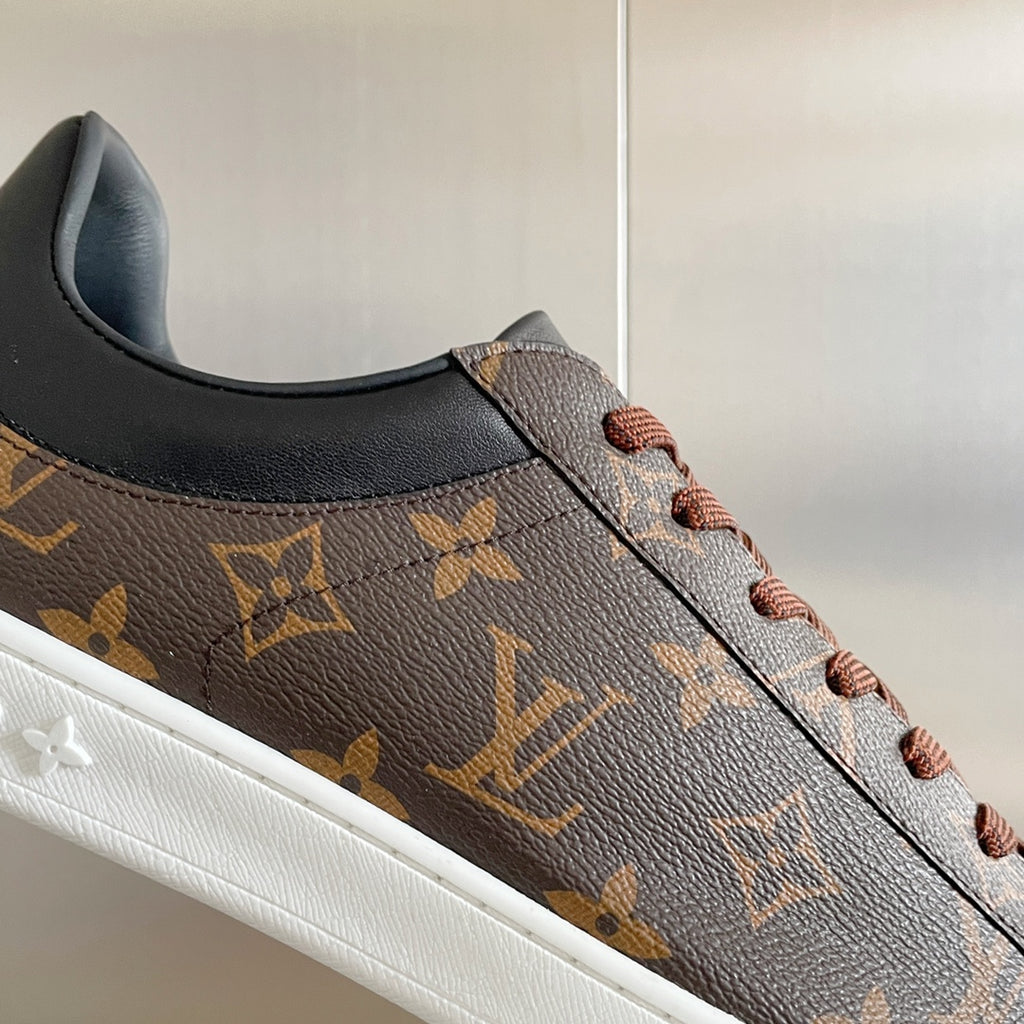 Louis Vuitton unisex sneaker side profile with monogram leather and brown lace-up.