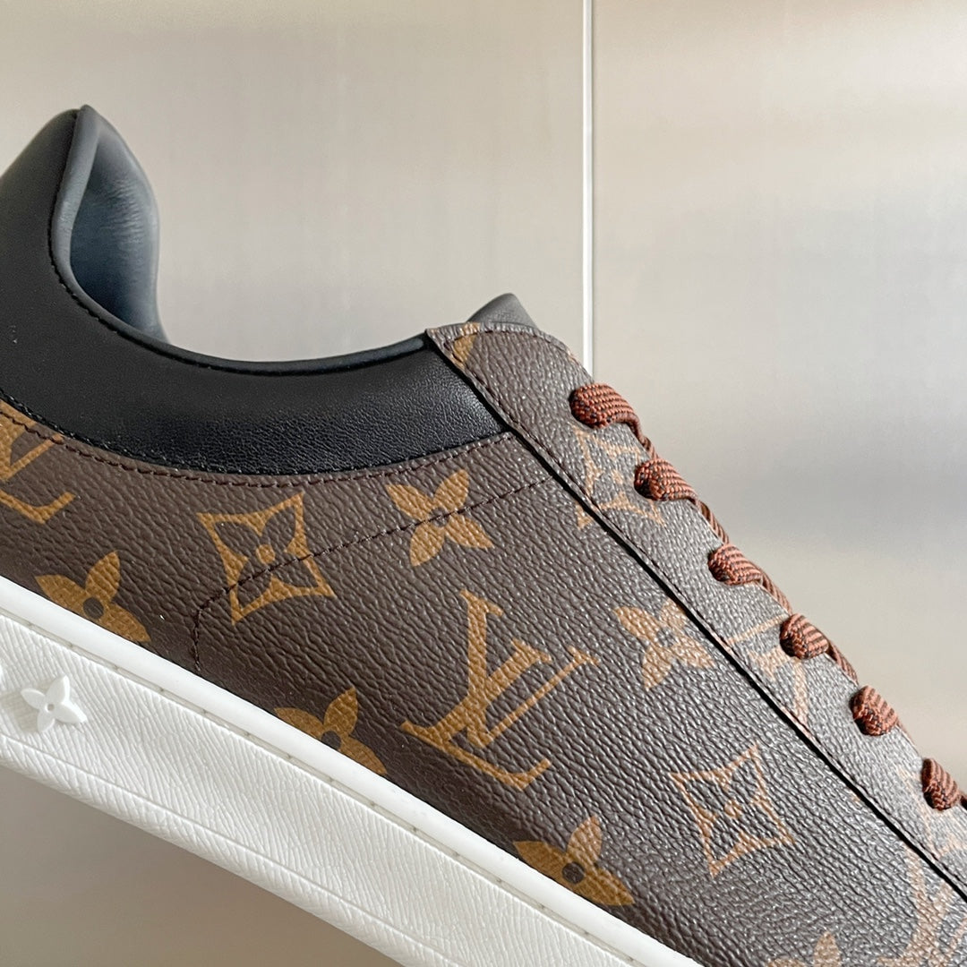 Louis Vuitton unisex sneaker side profile with monogram leather and brown lace-up.
