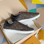 Louis Vuitton unisex sneakers with monogram print, lace-up front, white rubber sole.