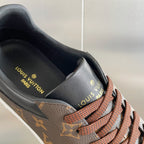 Louis Vuitton unisex sneaker heel with Louis Vuitton print and brown laces.