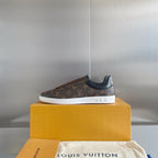 Louis Vuitton unisex sneakers with monogram canvas, lace-up design and white sole.