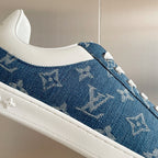 Louis Vuitton blue denim sneaker with white sole and monogram pattern, side close-up