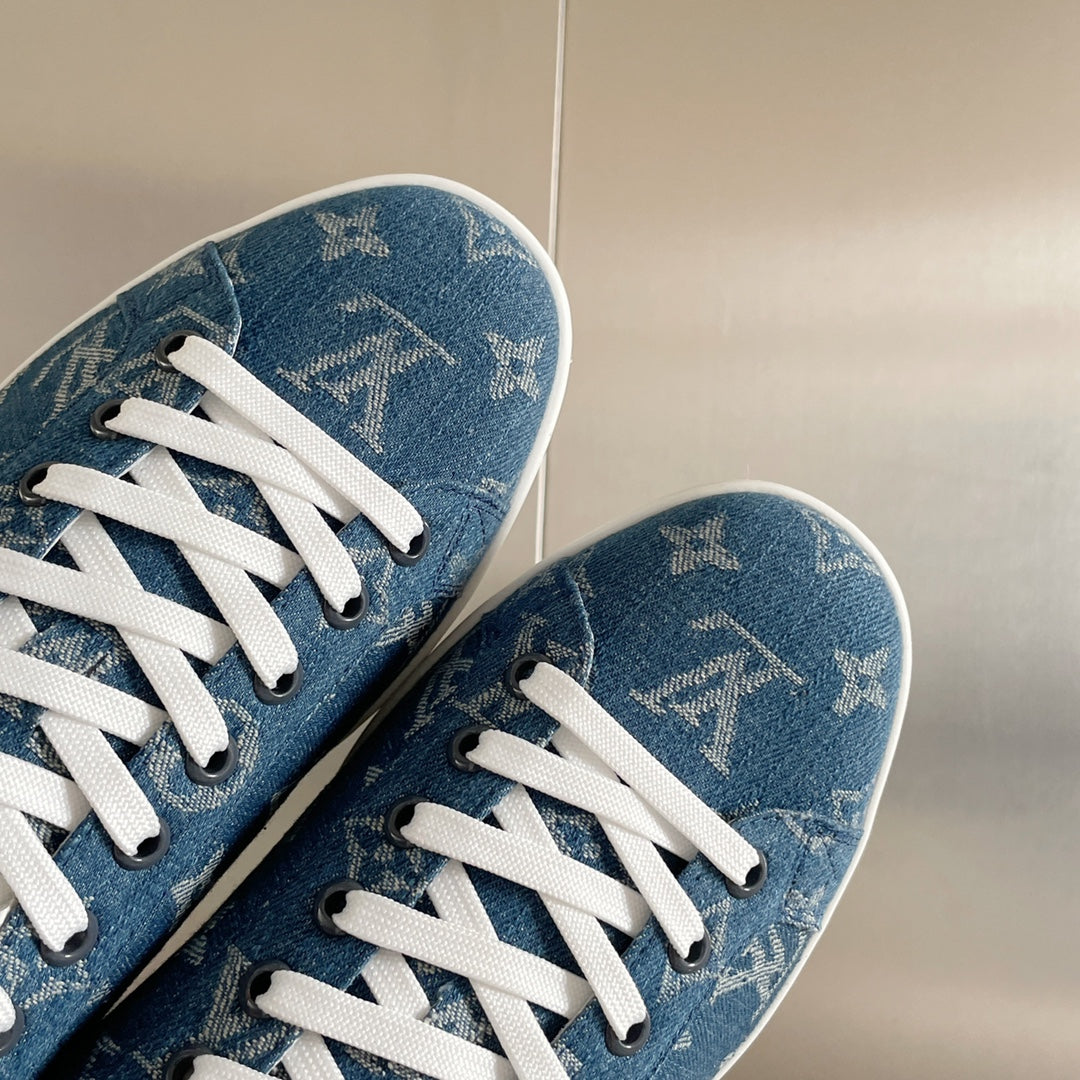 Close-up of Louis Vuitton blue monogram sneakers with white laces