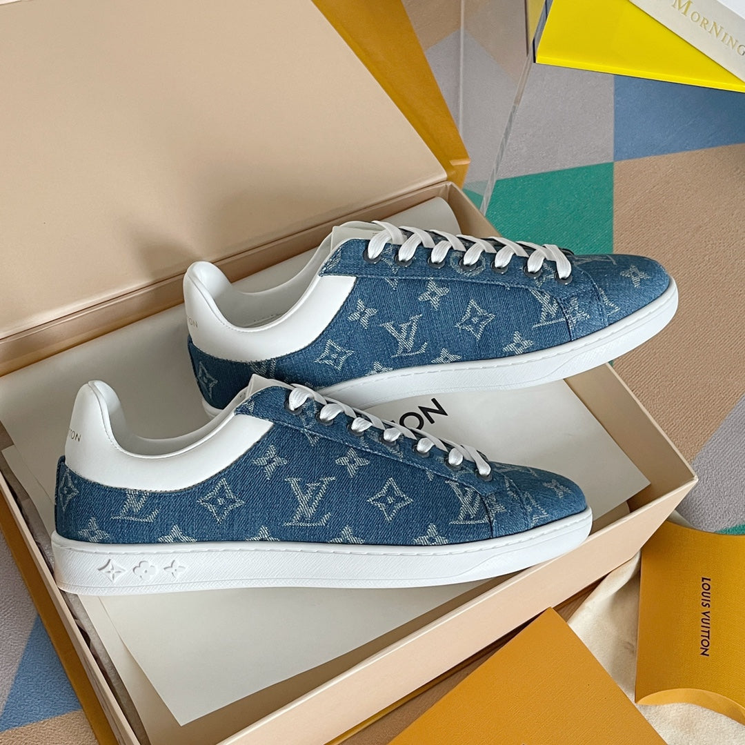 Louis Vuitton blue denim sneakers with white midsoles and monogram print, close view