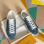 Pair of Louis Vuitton sneakers in blue denim with white laces on box
