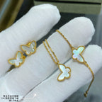 Gold butterfly earrings held in white fabric gloves