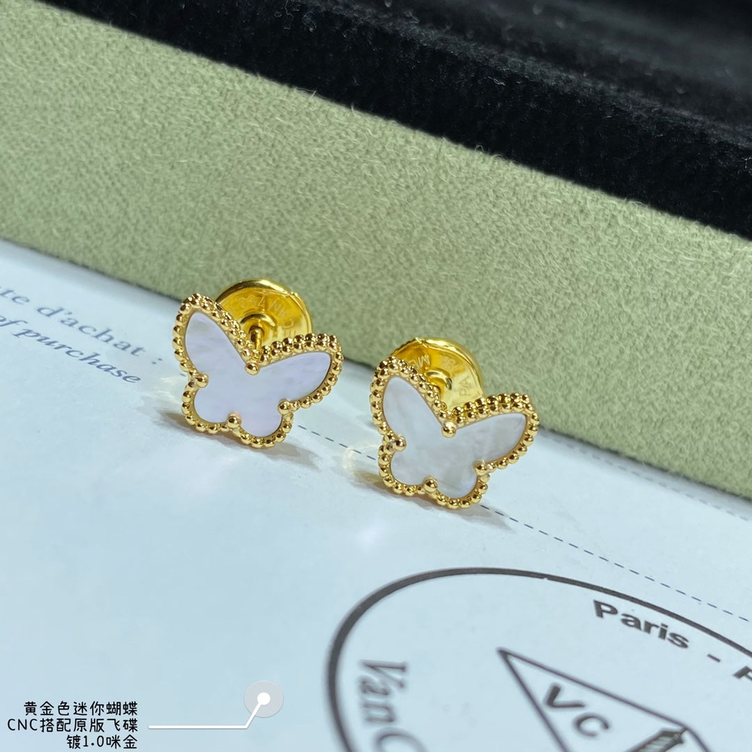 Pair of gold butterfly hoop earrings on a display card