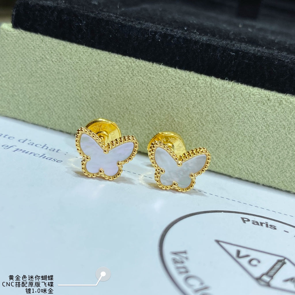 Gold butterfly hoop earrings on a display card with Paris text