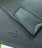 Louis Vuitton bag interior label on dark pebbled leather with stitched border