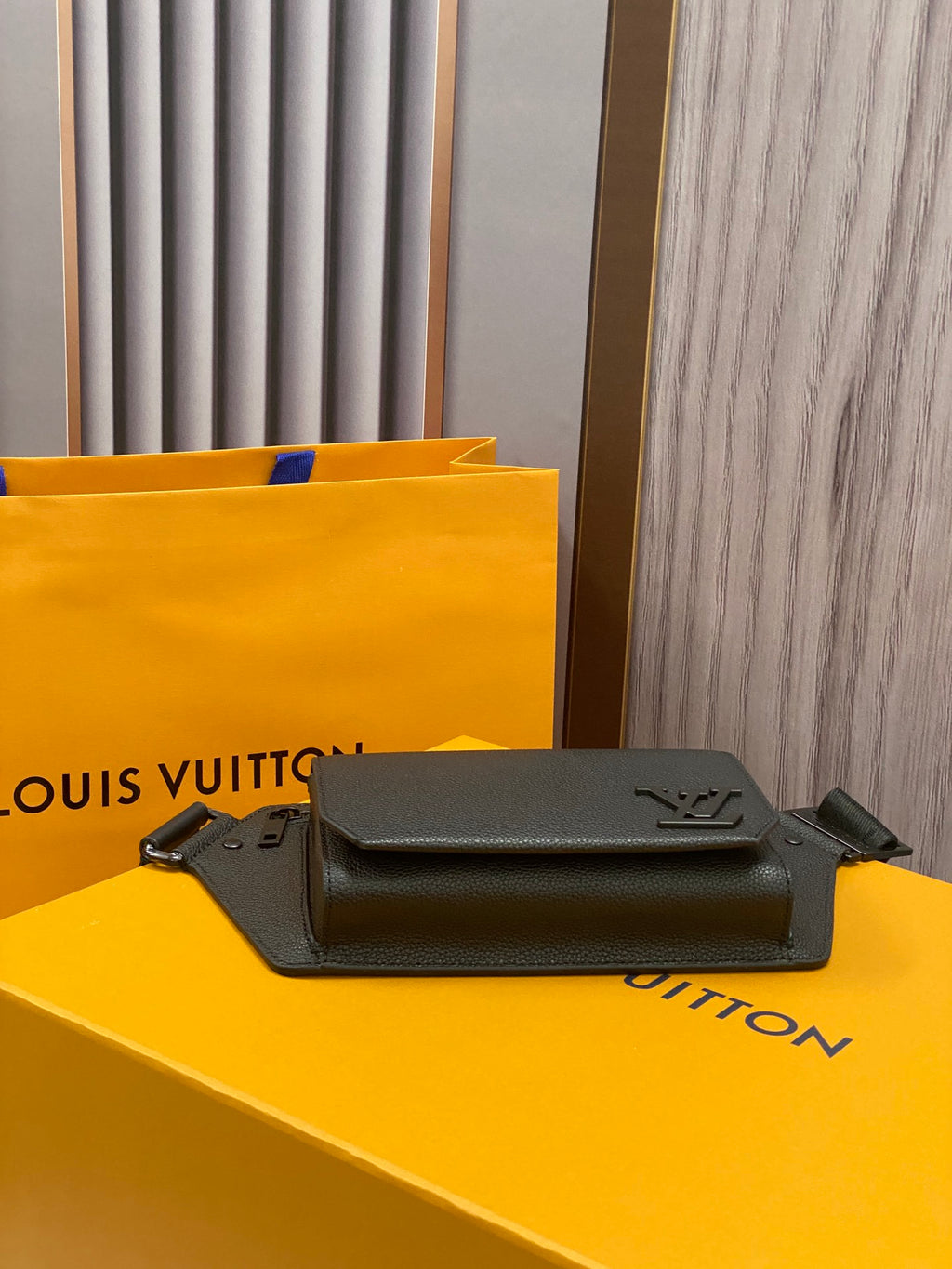 Louis Vuitton small crossbody bag with dark textured leather and LV front logo