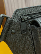 Louis Vuitton bag side view with dark textured leather, snap hardware, and zipper pull