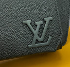 Louis Vuitton bag detail: dark pebbled leather with embossed LV monogram on flap
