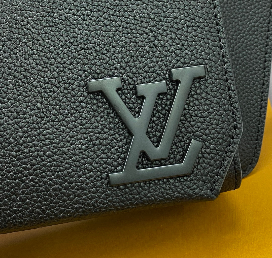 Louis Vuitton bag detail: dark pebbled leather with embossed LV monogram on flap